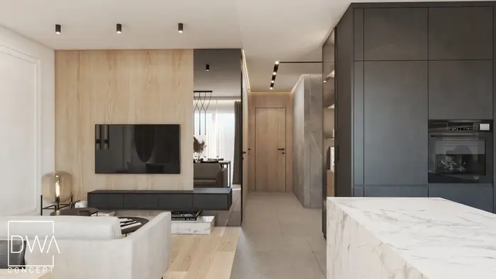 Salon z telewizorem na drewnianej ścianie i przejściem do kuchni z czarną zabudową - apartament w Krakowie