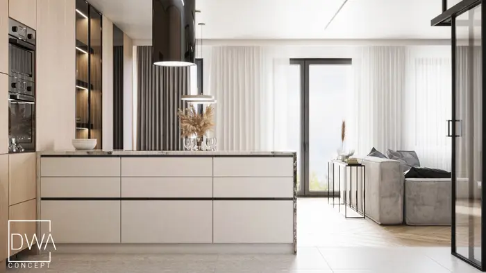 Otwarta strefa kuchenno-dzienna z marmurową wyspą i sofą w tle - apartament w Krakowie